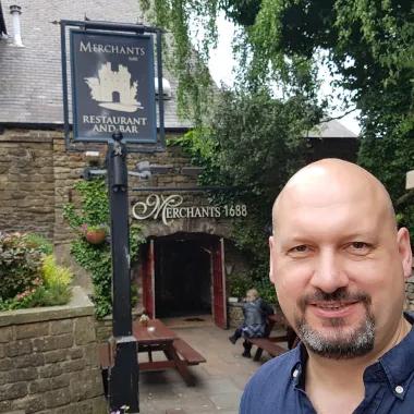 Man standing outside of a pub