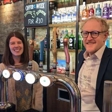 PCA team members pose behind pub bar