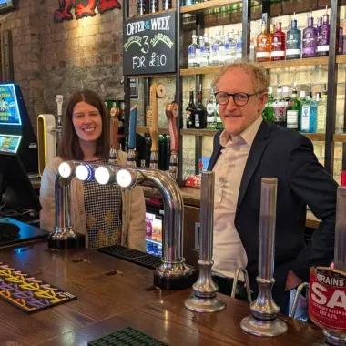 PCA team members pose behind the bar.